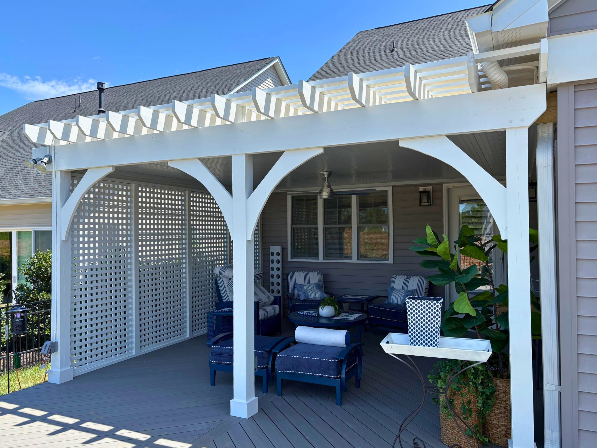 Custom white pergola with privacy fence and covered roof in charlotte, NC.